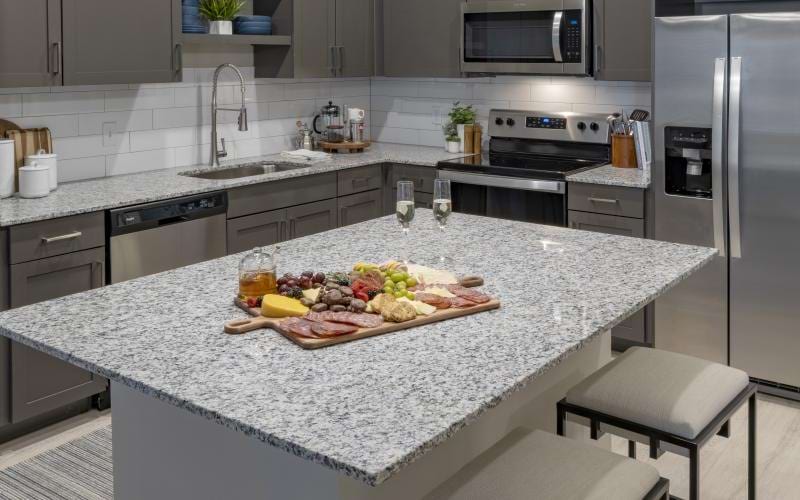 a kitchen with a marble counter top